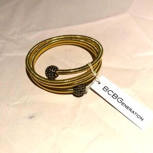 Gold tone flexible bracelet with black rhinestones